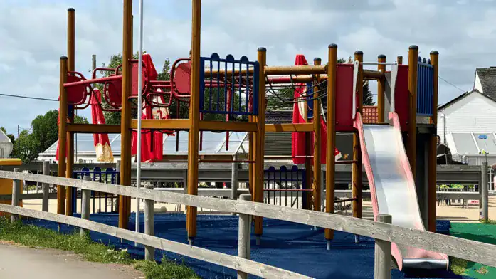 Traditional British pub meal setting Colorful playground with slides and climbing structures at Rose & Crown.
